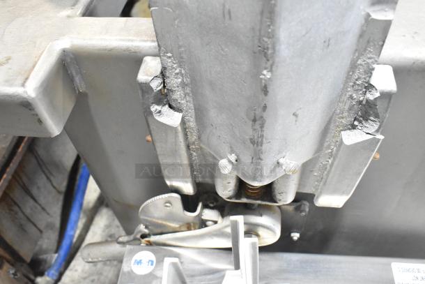 Commercial floor style meat saw, 208-220/440 volts, metallic structure, industrial use, visible wear, suitable for high-capacity cutting.