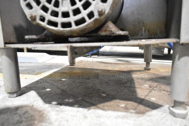 Commercial floor-style meat saw in used condition, 208-220/440V, featuring an industrial-grade motor and sturdy base.