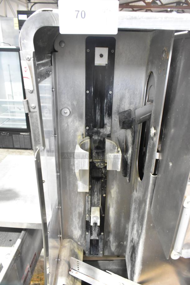 JBT 2ND-GEN-MFJ-HE citrus juicer with commercial casters, 115V, 1-phase, shows interior mechanism, used condition.