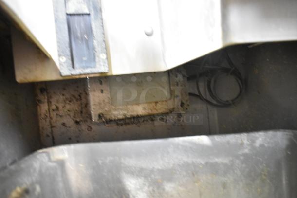 JBT 2ND-GEN-MFJ-HE citrus juicer interior view, showcasing internal components and wiring. Slight wear visible.