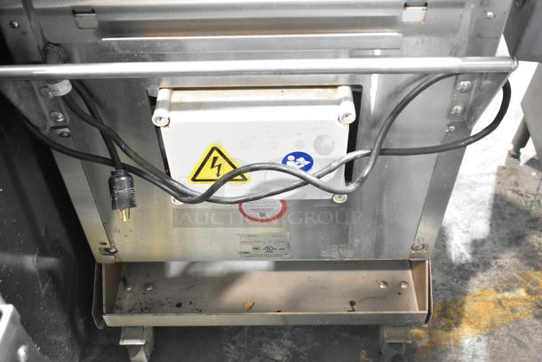 JBT Fresh N Squeeze commercial citrus juicer, 2ND-GEN-MFJ-HE, on casters, 115V, 1 Phase, visible warning labels and power cord.