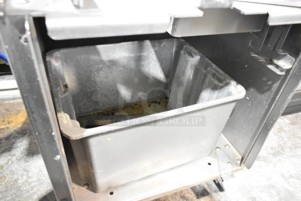 JBT 2ND-GEN-MFJ-HE citrus juicer interior view, showing stainless steel components and commercial casters. 115V, 1 Phase.