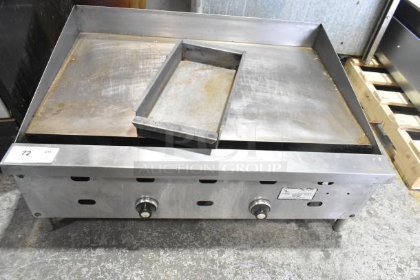 Commercial countertop gas-powered flat top griddle, stainless steel, dual control knobs, visible wear, ideal for kitchens.