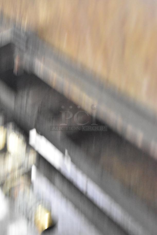 Blurry image of a commercial countertop gas-powered flat top griddle. Details and features are unclear.