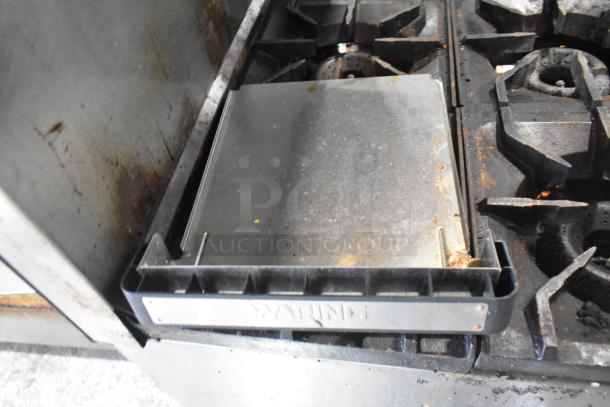 American Range gas-powered 6 burner commercial stove with oven, overshelf and backsplash. Visible wear and usage marks.