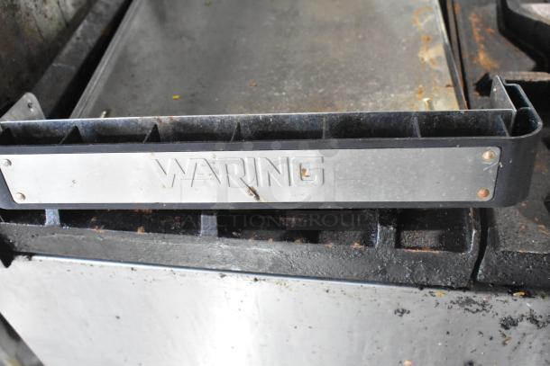 American Range 6-burner gas range with oven, over shelf, backsplash, and commercial casters in used condition.