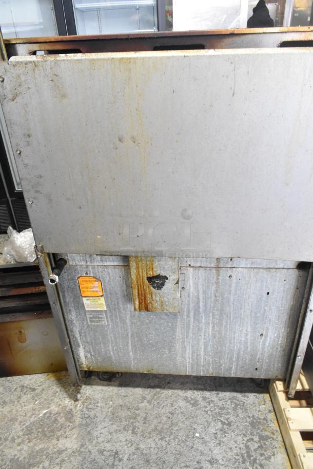 American Range commercial gas-powered 6 burner floor style range with oven, over shelf, backsplash, on casters. Visible wear.