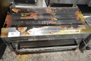 American Range Commercial Gas Powered Cheese Melter, showing signs of heavy use with rust and charring, model details visible.