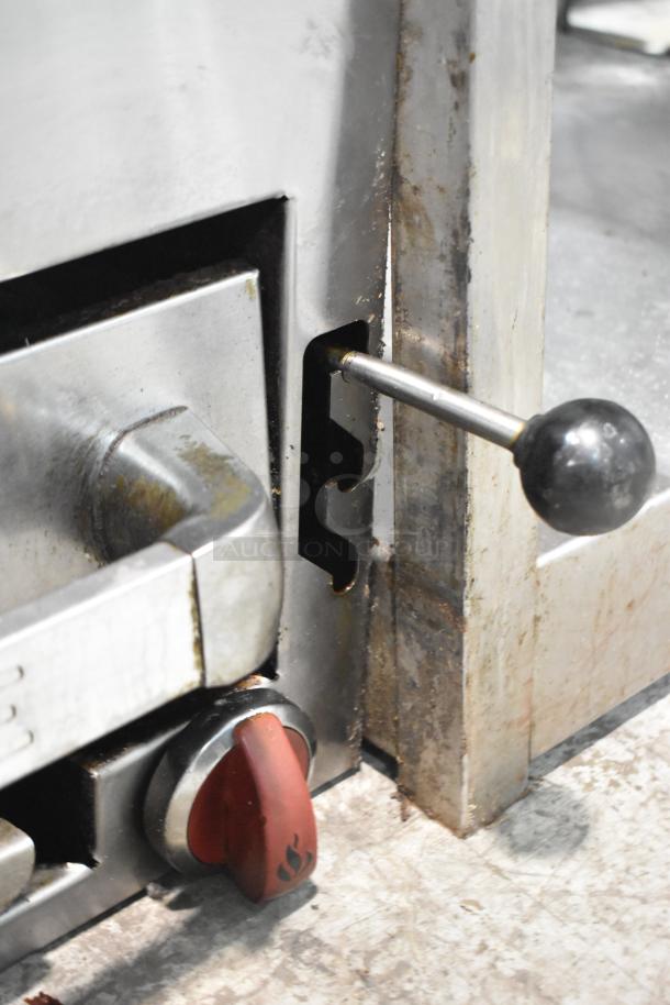 American Range commercial gas cheese melter, stainless steel, visible wear, features flame control knob and handle.