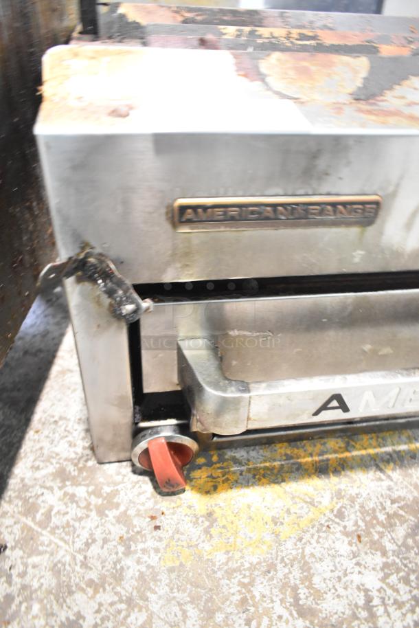 American Range commercial gas cheese melter, stainless steel, visible wear, branded label "AMERICAN RANGE".