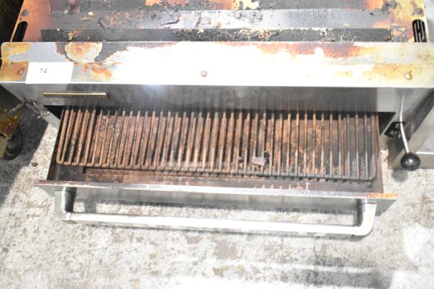 American Range commercial gas cheese melter, showing visible signs of wear and rust. Model details not visible.