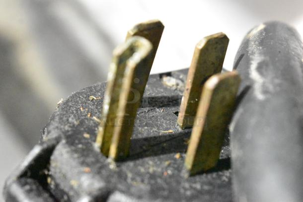 Close-up of the plug for a Groen XS-248-12-3 Intek stainless steel steamer. Shows three prongs, slight wear visible.