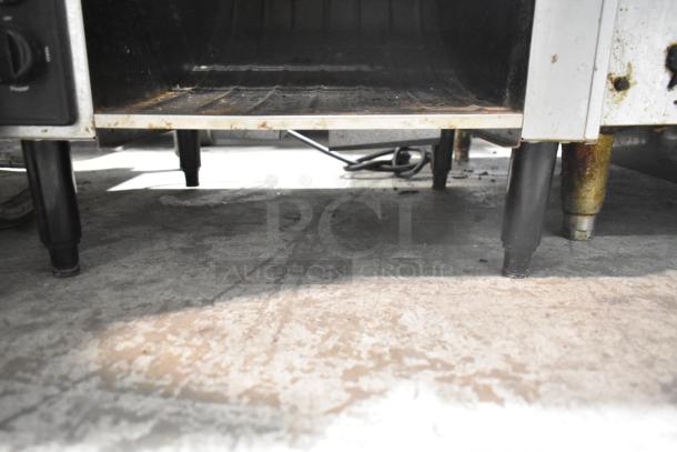 Waring CTS1000B Conveyor Toaster Oven, 208V, 1 Phase. Visible wear, underside view showing legs and power cord.