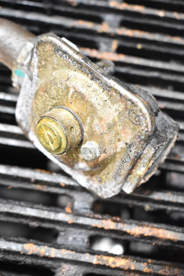 Star Max Commercial Gas Charbroiler Grill, showing detailed view of burner component. Used condition with visible wear.