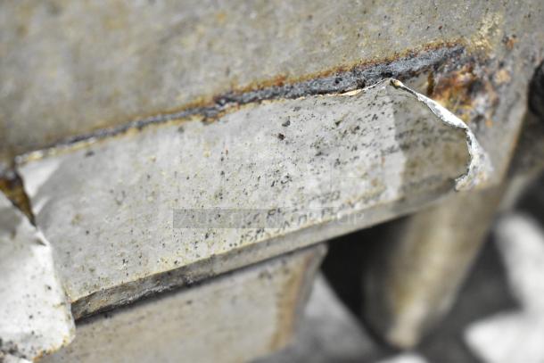 Star Max countertop gas charbroiler, worn condition, shown close-up of peeling, slightly rusted surface with faded label.