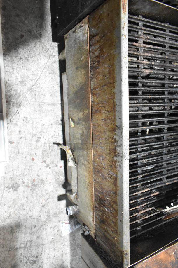 Star Max commercial countertop gas charbroiler grill with visible rust and wear, metal grates, and a side gas connector.