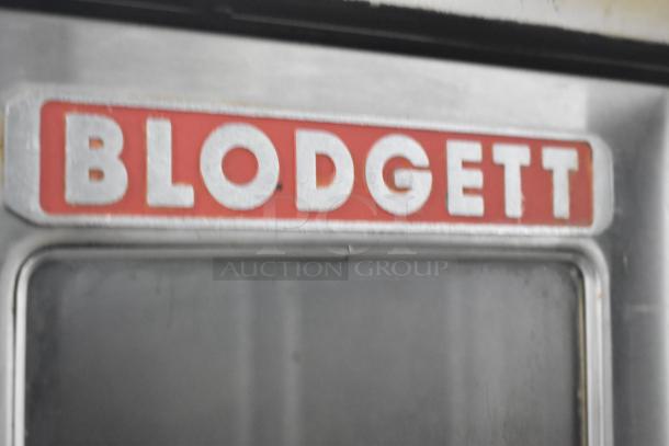 Blodgett DFG-100-3 convection oven, view-through doors, thermostatic controls, commercial casters, close-up logo.