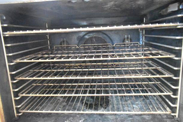 Inside view of Blodgett DFG-100-3 convection oven with multiple wire racks, view-through door, and commercial-grade interior.