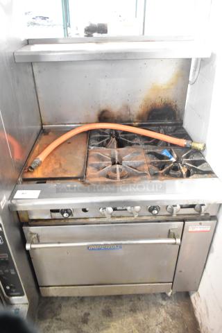 Imperial IR4-G12 commercial gas flat top griddle with four-burner range, oven, overshelf, backsplash, on casters; used condition.