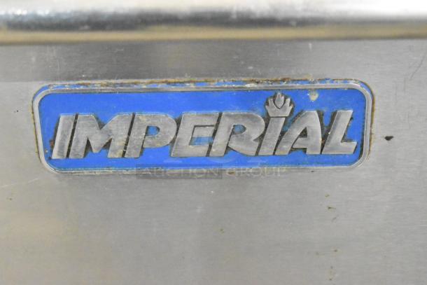 Imperial logo on stainless steel, indicating an Imperial IR4-G12 commercial griddle and range unit, featuring a durable finish.