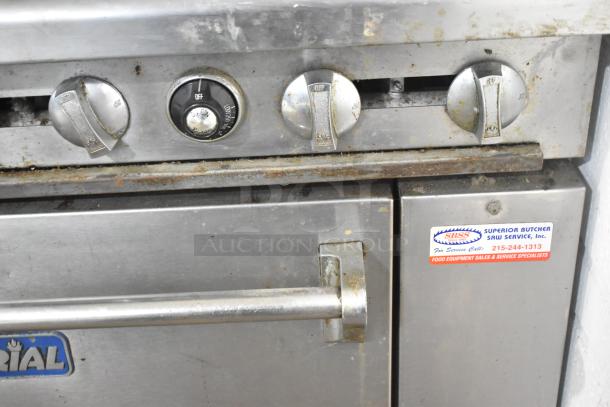 Imperial IR4-G12 commercial gas griddle and range, visible controls, visible wear, service label attached, on casters.