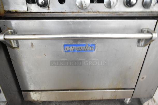 Imperial IR4-G12 gas griddle with 4-burner range, oven, overshelf, backsplash, on casters. Shows signs of use.