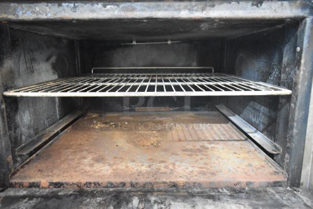 Imperial IR4-G12 commercial oven interior, showing a used condition with a wire rack and visible wear on surfaces.