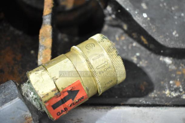 Close-up of a brass gas flow regulator with a "GAS FLOW" label and model markings, part of the Imperial IR4-G12 unit.