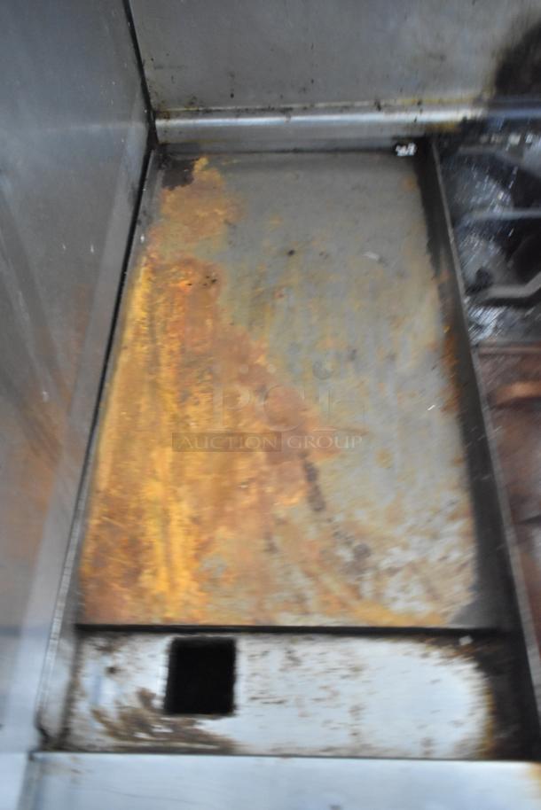 Imperial IR4-G12 commercial griddle with rust and wear. Features include 4 burners, oven, overshelf, and backsplash.