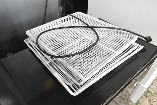 Frigidaire FGFRF7009-B-BLACK-6COM chest freezer; black, 115V, 1 phase, shown with white racks and power cord.