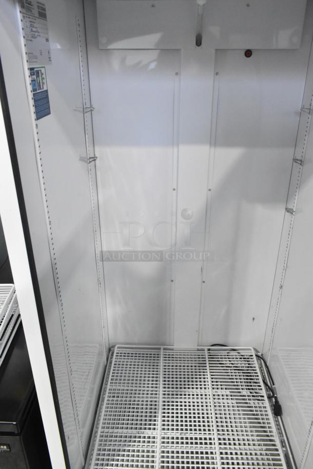 2021 True TSCI-600R-G-PH commercial cooler, single glass door, clean interior, 115V, 1 phase, shelving supports visible.