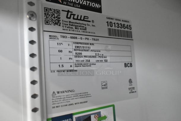 Label of True TSCI-600R-G-PH cooler shows model, voltage, phase, compressor info, and refrigerant type R290.