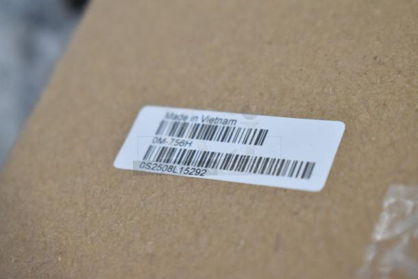 Label showing "Made in Vietnam" with barcodes and alphanumeric codes on a cardboard surface.