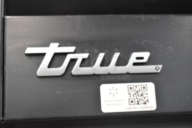 True STG2RPTVLD-2G-2S-HC logo and maintenance tag on a 2017 commercial 2 door reach-in cooler merchandiser.