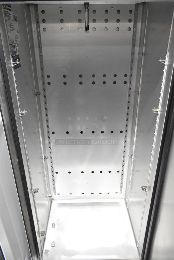 2022 True T-19F-HC commercial freezer interior, pristine condition, with adjustable shelves, model and energy labels visible.