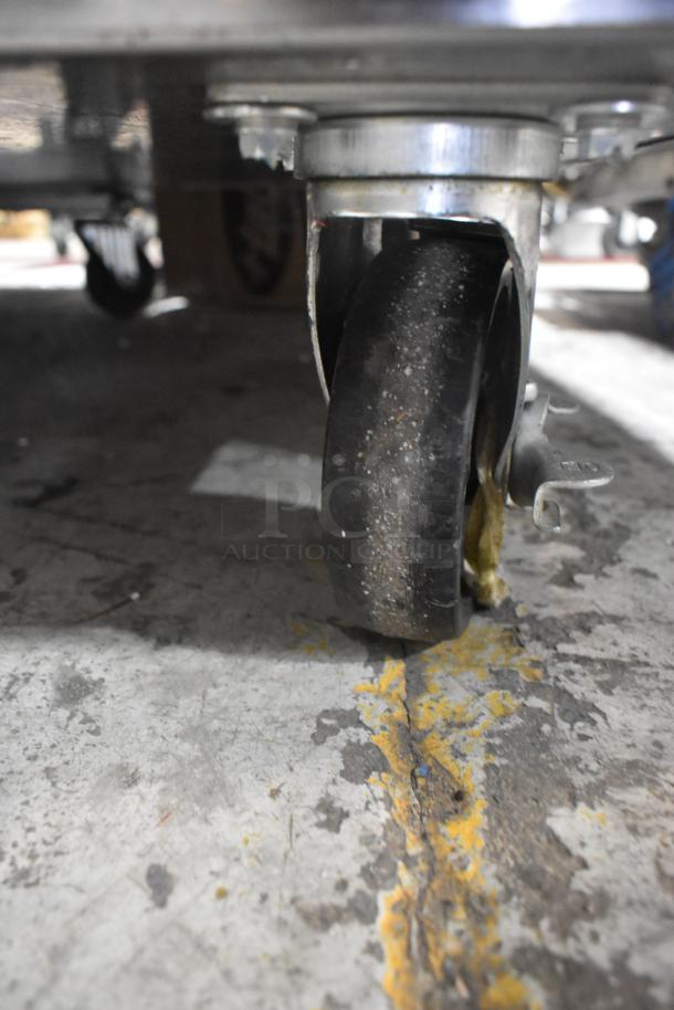 2023 Vulcan VBP15ES commercial heated holding cabinet caster, showing wear, on concrete floor.