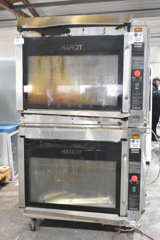 Two Hardt Inferno 4500 natural gas rotisserie ovens, each with 40 bird capacity, on commercial casters. Model labels visible.