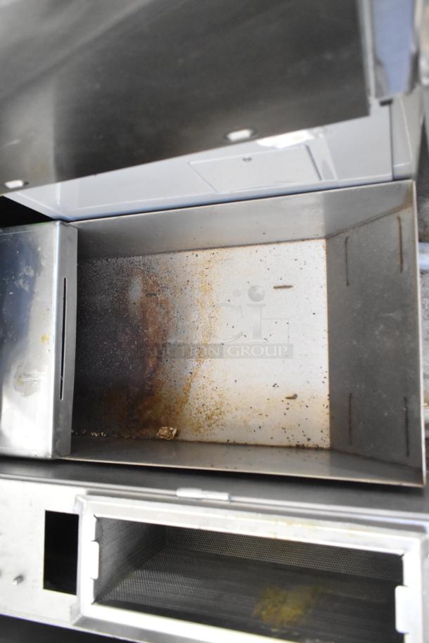 Frontline 10SS stainless steel commercial oil filtration system, visible internal chamber, commercial casters, used condition.