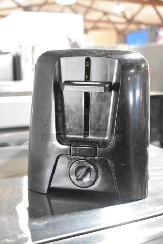 Countertop 2-slot toaster, black, visible dial. Condition shows wear. 115 volts, 1 phase power.