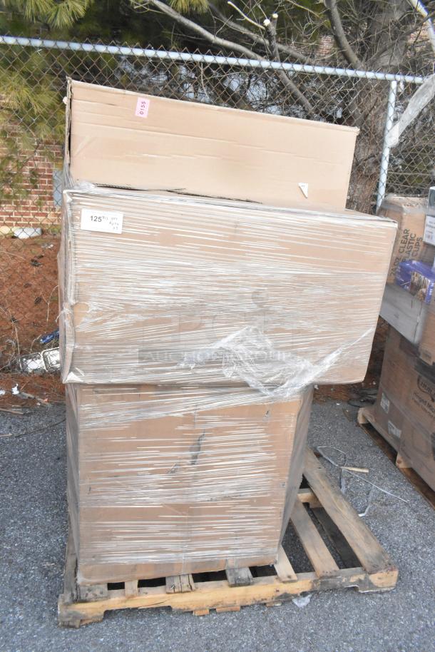 Stack of new boxed items on a pallet, wrapped in plastic. Includes side stools and a mop sink. Scratch and dent condition.