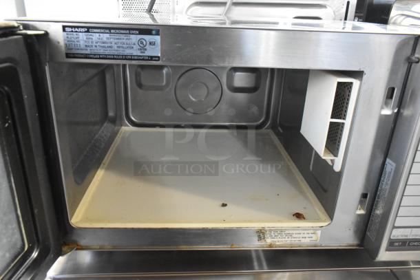 2021 Sharp R-21LVF Commercial Microwave Oven, 120V, 1 Phase, stainless steel interior, pre-owned condition, slight residue.