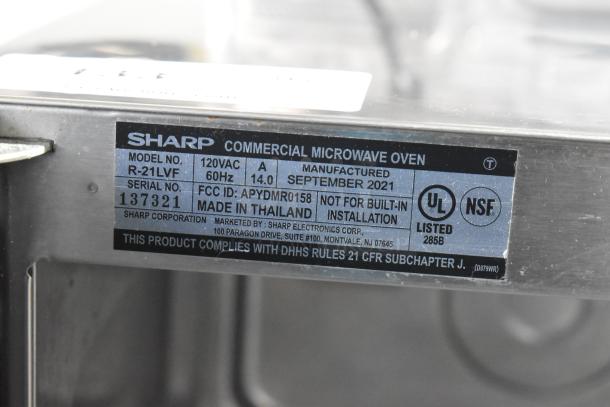 Sharp R-21LVF Commercial Microwave Oven label showing specifications, manufactured September 2021, UL and NSF listed.
