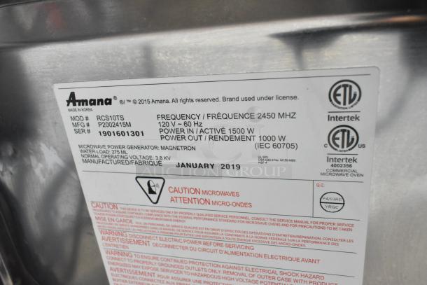 2019 Amana RCS10TS commercial microwave oven, 120V, model details plate showing specs and safety instructions.