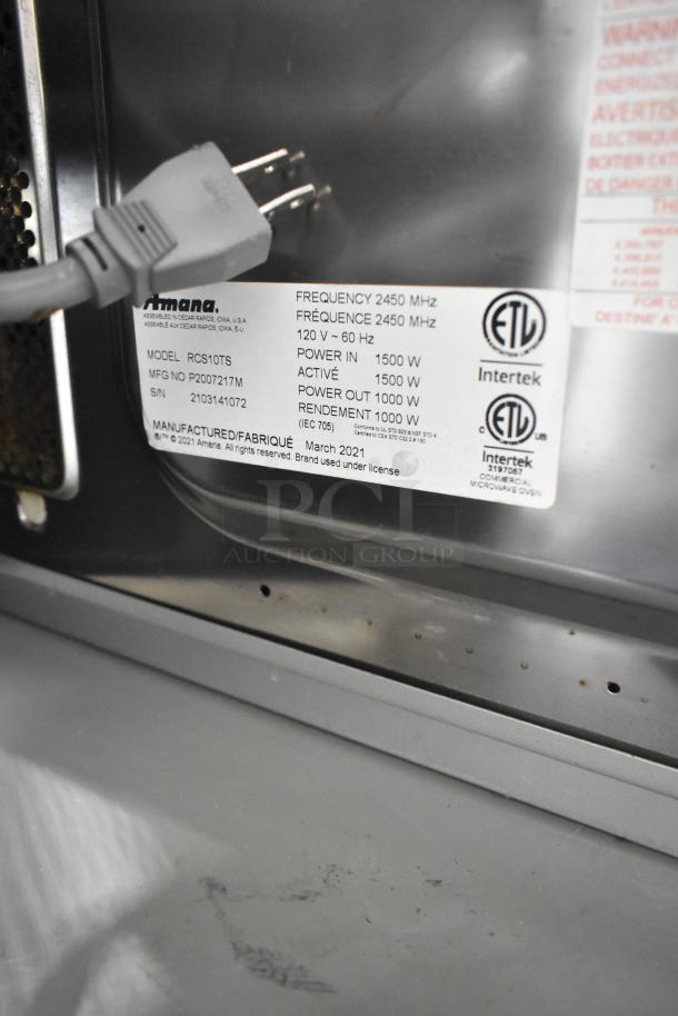 2021 Amana RCS10TS commercial countertop microwave oven, 120 volts, labeled with model and manufacturing details.