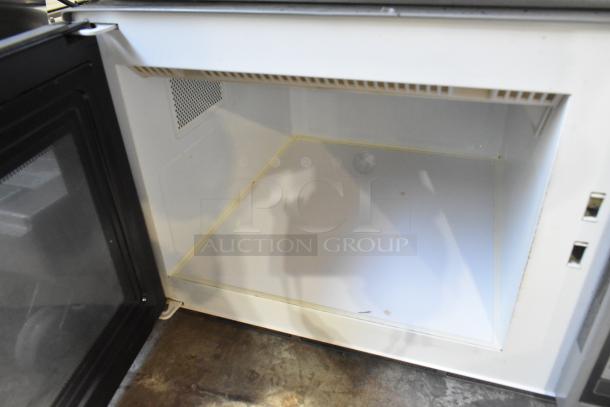 Amana Commercial Countertop Microwave Oven, open, showing interior. 120 Volts, 1 Phase. Condition: used, minor wear.