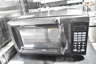 2020 Mainstays EM720CGA-B countertop microwave oven, black, visible control panel, 120 volts, pre-owned condition.