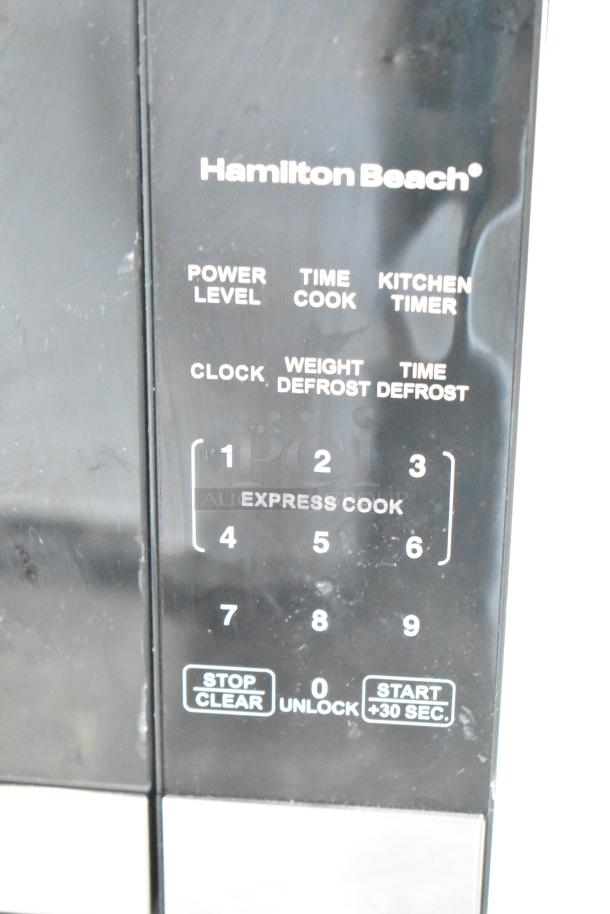Hamilton Beach HB8436127995-03 microwave, black control panel, 120V, 1 phase, shows cooking functions and express cook keypad.