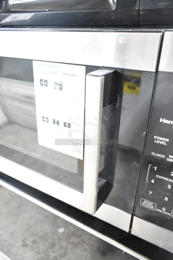 Hamilton Beach HB8436127995-03 countertop microwave oven with stainless steel handle, shown in good condition. 120 Volts, 1 Phase.