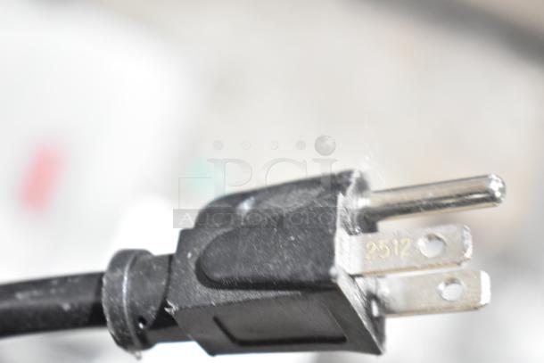 Close-up of a power plug for the Hamilton Beach HB8436127995-03 countertop microwave, showing prongs and partial serial number.