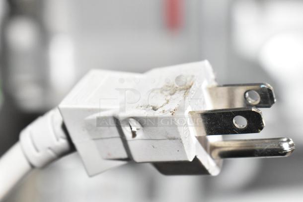 Close-up of a power plug with signs of wear, linked to the Panasonic NN-SN975S countertop microwave oven.
